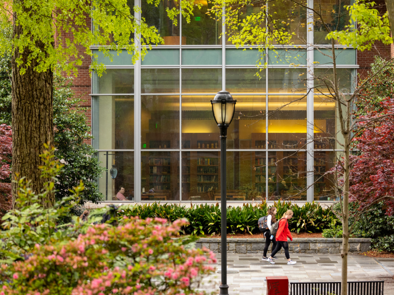 Image of two students walking on campus